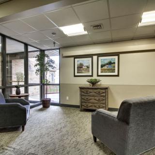 A cozy lobby area with chairs, decorations, and natural light.