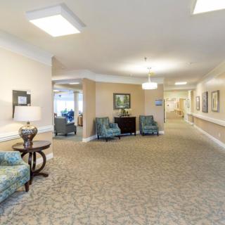 A well-lit hallway with comfortable seating and elegant decor.