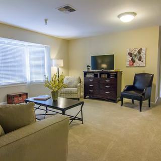 A cozy living room with modern furniture and neutral tones.