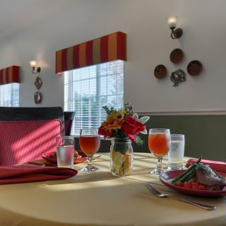 A beautifully set dining table with floral centerpiece and elegant decor.