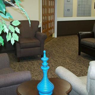 A cozy lobby area with comfortable seating and a decorative blue vase on the table.