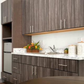 A modern kitchen with sleek cabinets and a well-organized countertop.