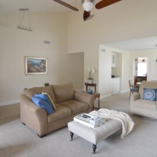 A cozy living room with sofas, a coffee table, and artwork on the wall.