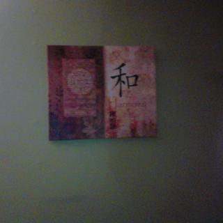 Abstract wall art featuring intricate designs and symbols on a green background.