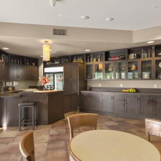Modern kitchen cafe area with wooden cabinets and seating.