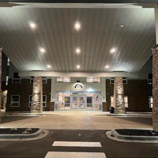The illuminated entrance of a modern building at night.