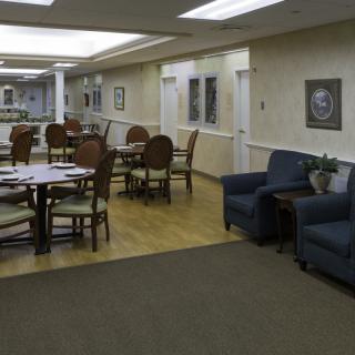 A spacious lounge area with tables, chairs, and comfortable seating.