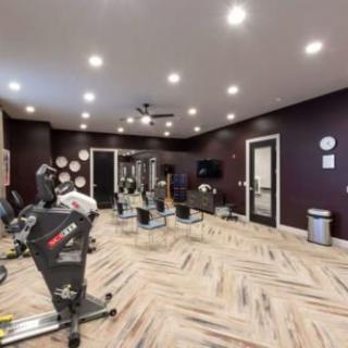 A modern gym with stationary bikes and exercise equipment in a well-lit fitness room.