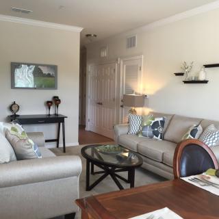 A modern living room featuring comfortable sofas, a glass coffee table, and stylish decor.