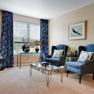 A cozy living room with blue accents and elegant furnishings.