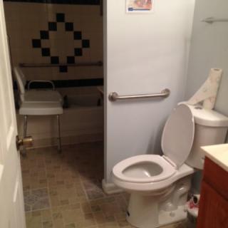An accessible bathroom with a toilet and grab bars.