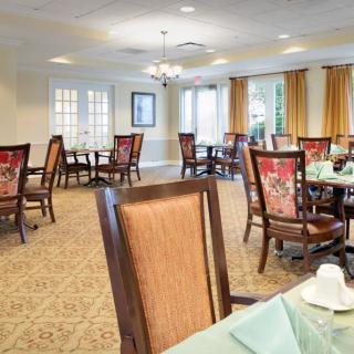 A spacious dining room with elegant furniture and decor.