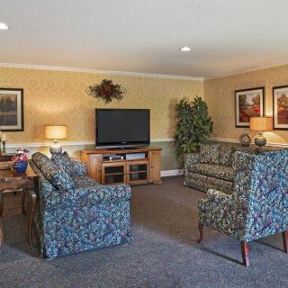 Cozy living room with patterned sofas and a television.