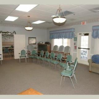 An empty meeting room with chairs arranged in a circle.