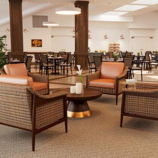 A modern lobby seating area with comfortable chairs and a central coffee table.