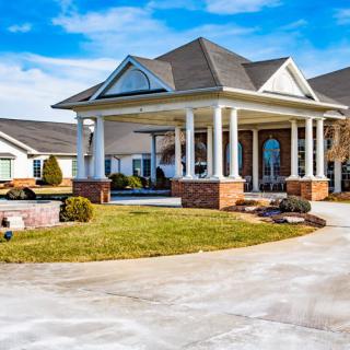 A beautiful residential home with a spacious driveway and landscaped garden.