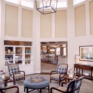 A well-lit living room featuring comfortable seating arrangements and stylish decor.