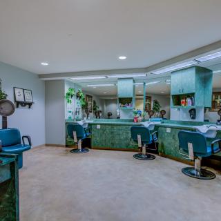 A modern salon interior with stylish chairs and mirrors.