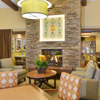 A cozy lounge area featuring a stone fireplace and comfortable seating, perfect for relaxation.