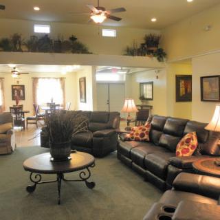 A spacious and elegantly designed living room featuring comfortable leather sofas and a stylish coffee table.