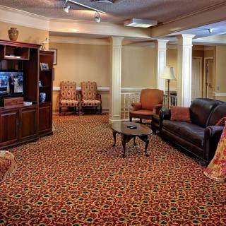 A cozy lobby with comfortable seating and patterned carpet.