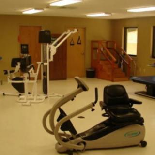 A room with various exercise equipment, possibly for fitness or rehabilitation purposes.