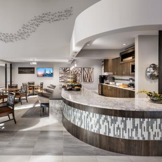 A modern restaurant interior featuring a stylish bar counter and cozy seating area.
