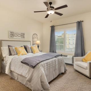 A cozy bedroom with neutral tones and stylish decor.