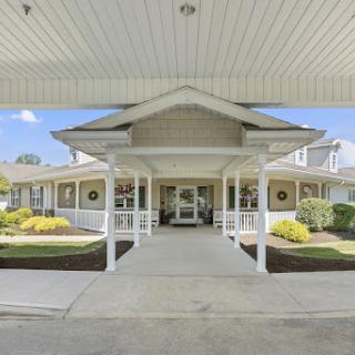 Welcoming entrance of a residential building with well-maintained landscaping.