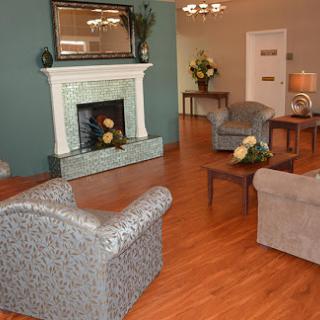 A stylish living room featuring a cozy seating area and a charming fireplace.