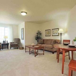A cozy living room with comfortable furniture and warm lighting.