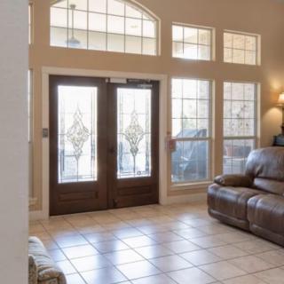 A spacious living room featuring large glass doors and comfortable seating.