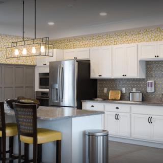 Modern kitchen with white cabinets, stainless steel appliances, and a stylish kitchen island.