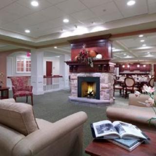 A cozy living room setting featuring a warm fireplace and comfortable furniture.