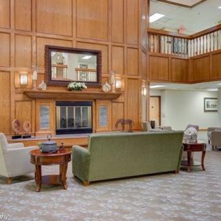A modern lobby featuring comfortable furniture and elegant wood paneling.
