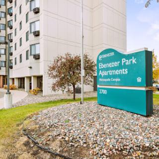 Entrance to Pioneer Park Apartments, showcasing the building and signage.