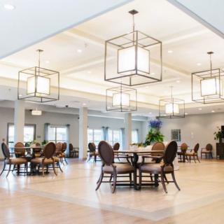 A modern dining area with stylish chandeliers and elegant furniture.
