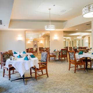 A beautifully arranged dining area featuring elegant tables and chairs, ready for guests.