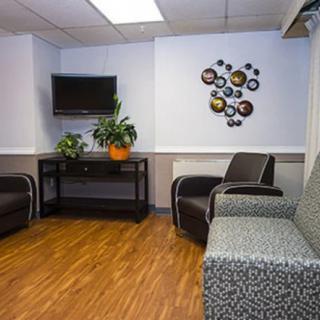 A modern waiting room with comfortable seating and decorative elements.