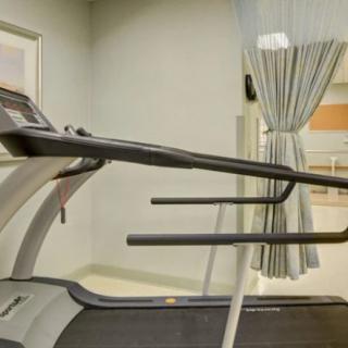 A treadmill is set up in a fitness room, ready for use.