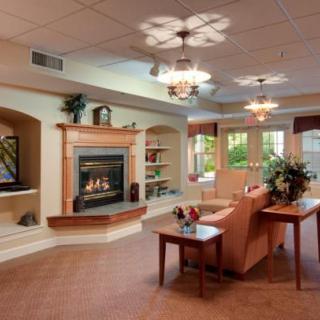 A cozy living room with a warm fireplace and comfortable seating.