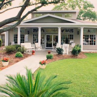 A charming house with a welcoming front porch and well-maintained garden.