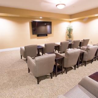 A cozy home theater setup with comfortable seating and a large screen television.