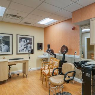 A well-equipped hair salon with chairs, mirrors, and styling stations.