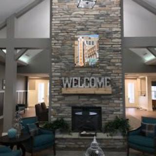 A welcoming lobby area featuring a large stone fireplace and comfortable seating.