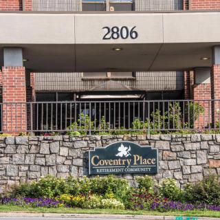 Entrance of an apartment complex with the address 2806 and a sign that reads 'Coventry Place'.