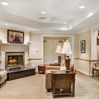 A cozy living room with comfortable seating and a warm fireplace.