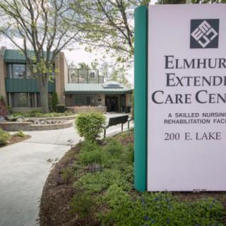 Entrance to Elmhurst Extended Care Center with a clear view of the facility sign.