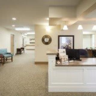 A modern reception area with a desk and seating in an office setting.