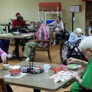 Elderly individuals engaging in activities at a nursing home.